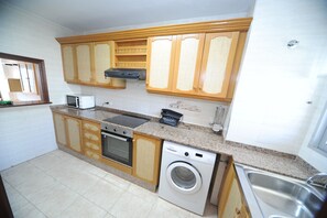 Fridge, microwave, coffee/tea maker, cookware/dishes/utensils