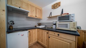 Fridge, microwave, coffee/tea maker, cookware/dishes/utensils
