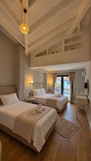 A hotel room with two beds, a balcony, a small table, and a ceiling with exposed beams. - No9 Alacati (Cesme)