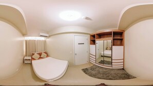 A compact bedroom with a bed, a wardrobe, a mirror, and an air conditioning unit. - Relaxing Sanctuary in Iloilo (Iloilo)