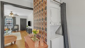 A modern living room with a sofa, coffee table, and decorative items. - Cute 2-bedroom bungalow in downtown Raleigh (Raleigh)