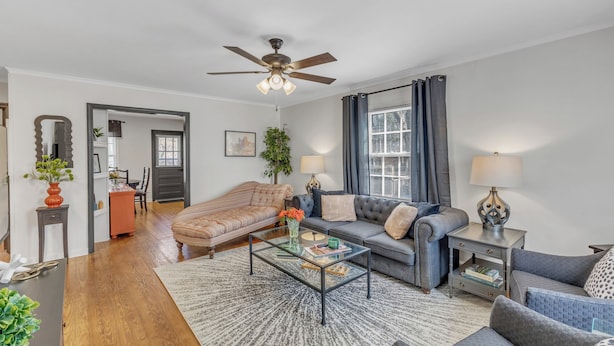 A living room with a sofa, armchairs, a coffee table, and a ceiling fan. - Cute 2-bedroom bungalow in downtown Raleigh (Raleigh)