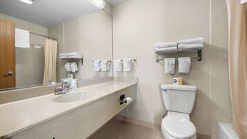 A bathroom with a sink, toilet, and towel rack.