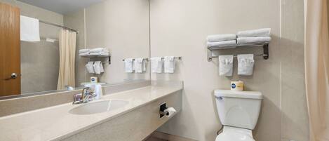 A bathroom with a sink, toilet, and towel rack.