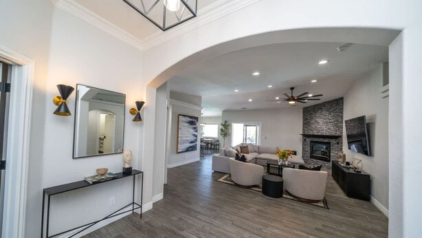A spacious living area with a fireplace, a large mirror, and a console table. - Lavish Lake Havasu Villa Pool Fire Pit an Views (Lake Havasu City)