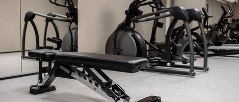 A row of stationary bikes in a gym.