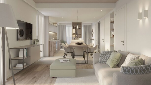 A modern living room with a sofa, ottoman, and a dining area with a table and chairs.