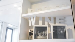 A white interior with large letters spelling 'PORTO WINE' and framed pictures of wine barrels.