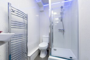 Shower, hair dryer, towels, toilet paper