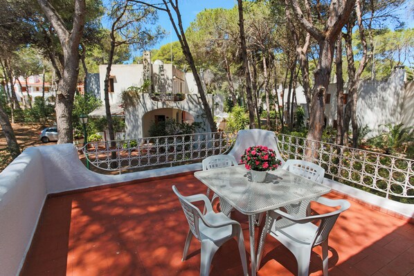 Relax on the patio with a potted plant and comfortable seating for four.