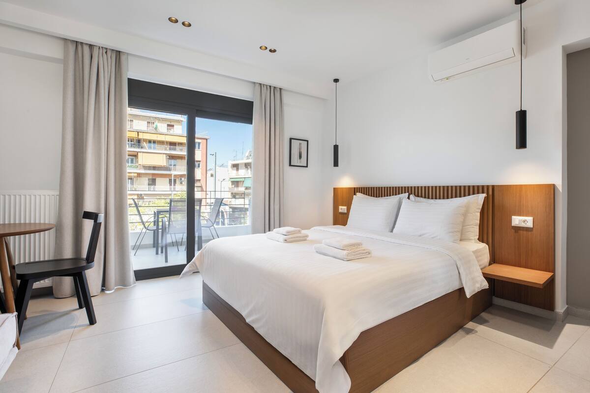 Deluxe Studio Suite, Balcony, City View | In-room safe, desk, laptop workspace, blackout drapes