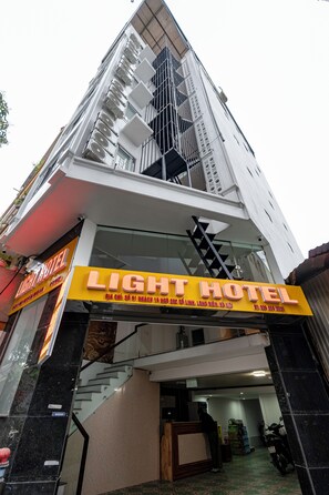 Stunning hotel exterior with a prominent staircase and bold signage.