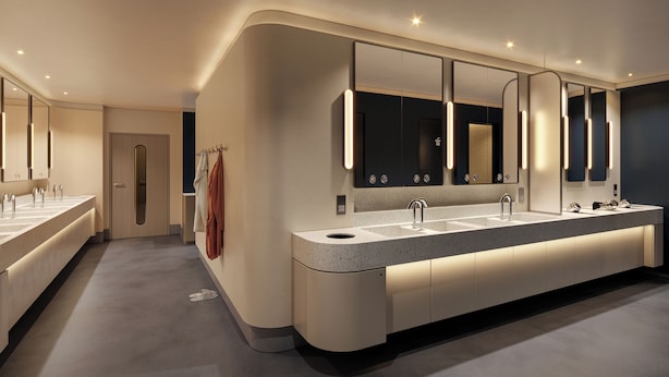 Une salle de bain moderne avec un long meuble-lavabo, deux vasques et un grand miroir.