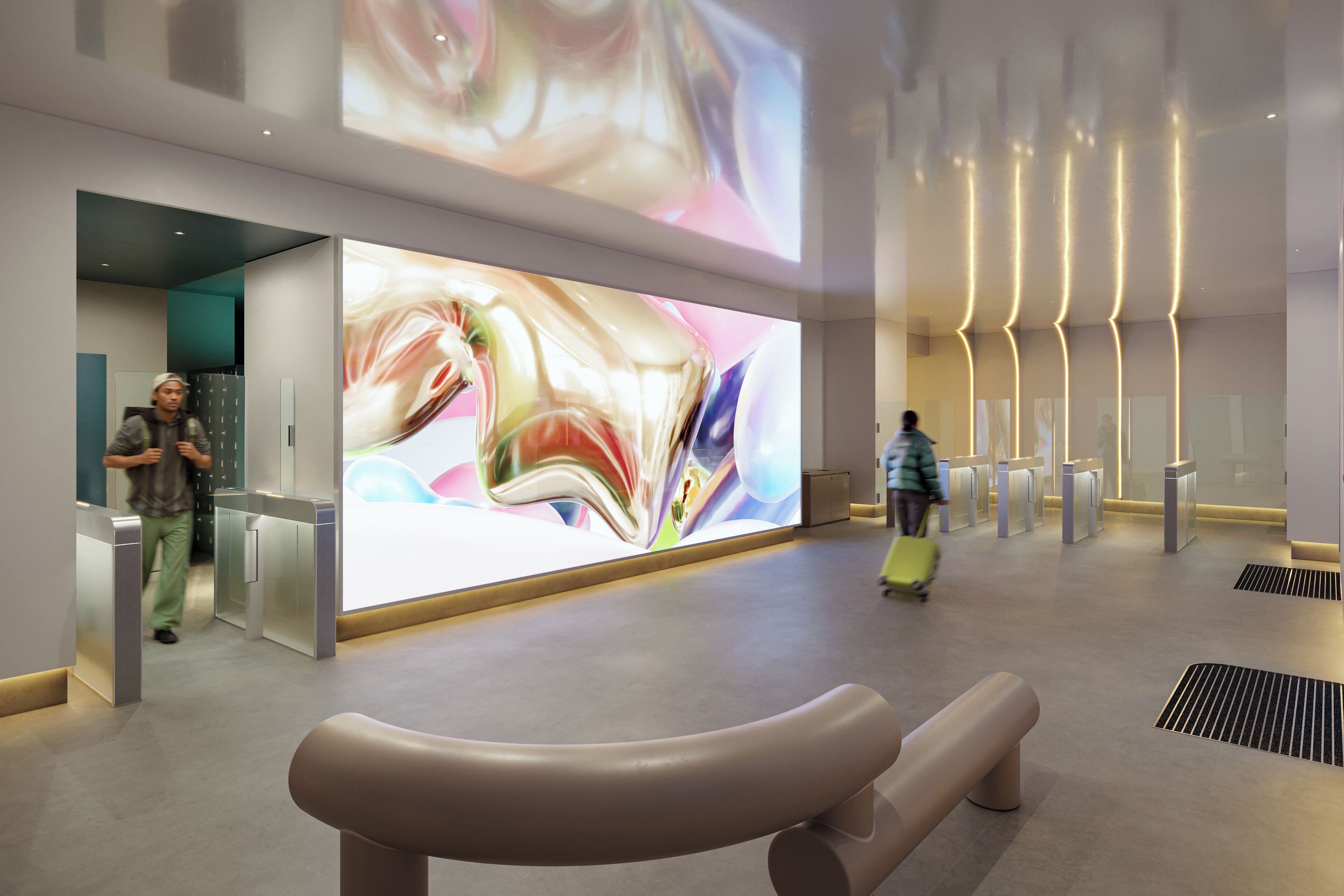 Un hall d’entrée moderne doté d’un grand écran numérique présentant des œuvres d’art, d’un espace salon et d’un comptoir d’enregistrement.