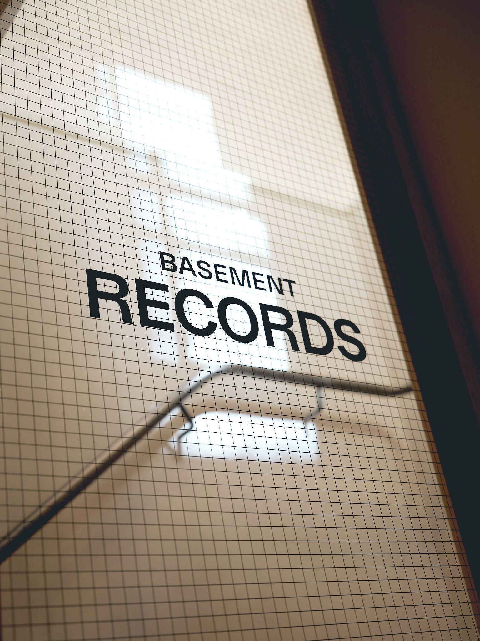 A grid pattern with the text 'BASEMENT RECORDS' on a wall.