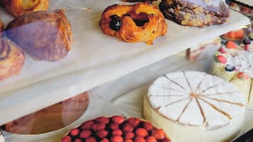A bakery display case with various pastries and cakes.