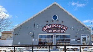 A building with a sign reading "AHNAPEF ALGOMA, WI BREWERY". - Upper River House Waterfront Getaway on Ahnapee River with Dock Boat Slip Wifi (Algoma)