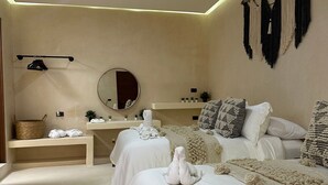 A bedroom with two beds, a vanity, and a mirror. - Ananda Hotel Boutique (Isla Holbox)