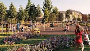 A park with a playground, walking paths, and a building in the background.
