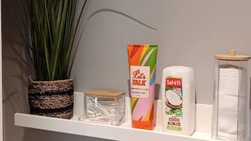 A shelf with a potted plant, a colorful box labeled 'Let's TALK,' and two toiletry items.
