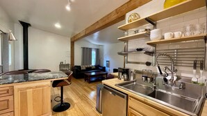 A modern kitchen with wooden cabinets, a built-in dishwasher, and a stainless steel sink.