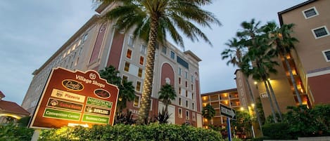 A hotel with a sign listing amenities like a game room, bowling, and a convention center.