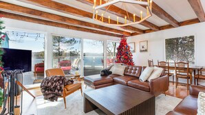 A cozy living room with a large sectional sofa, a wooden coffee table, and a Christmas tree. - Stunning Lake Views To Die For On Lake Arrowhead (Lake Arrowhead)