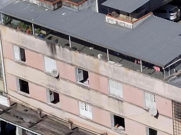 Residential building with balconies and laundry facilities.
