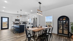 A modern kitchen with white cabinets, stainless steel appliances, and a central island. - 7 min to Wild Turkey and Four Roses - Sleeps 10 - Patio with Grill and View (Lawrenceburg)