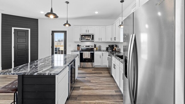 A modern kitchen with white cabinets, stainless steel appliances, and a marble countertop. - 7 min to Wild Turkey and Four Roses - Sleeps 10 - Patio with Grill and View (Lawrenceburg)