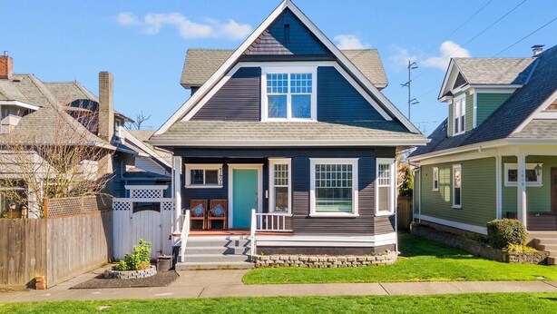 A two-story house with a gabled roof, a front porch, and a small front yard. - The Cushman House B: Unit B near 6th Ave UPS UW Ruston (Tacoma)