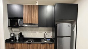 A modern kitchen with a microwave, stove, sink, and refrigerator. - Welcome to Ruelle505 (Tijuana)
