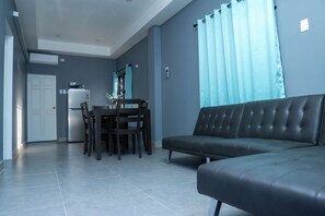 Exclusive Suite, Multiple Beds, Kitchenette, Courtyard View | Living area | TV