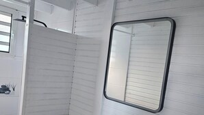 A bathroom with a white sink, a mirror, and a toilet.