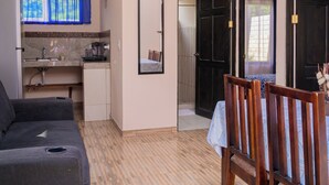 A compact living space with a kitchenette, a dining area, and a sofa. - APARTMENT EL JOBO, LA CRUZ, AT 700 MTRS COPAL BEACH, 8 MIN FROM RAJADA (Provincia de Guanacaste)