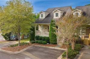 A two-story house with a front porch, a garage, and a well-maintained lawn.