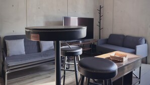 A modern living room with a sofa, a coffee table, a TV, and a wooden floor. - Apartment Tlaquepaque | Panoramic View | Swimming Pool | Terrace | Gymnasium (San Pedro Tlaquepaque)