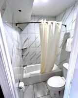 Combined shower/tub, towels, soap, shampoo