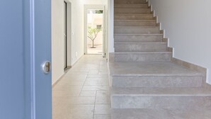 A staircase leading to an outdoor area with a tree. - Palmaiola by Interhome (Follonica)