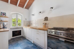 Cafetera o tetera, frigorífico, placa de cocina y utensilios de cocina