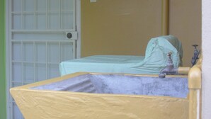 A small room with a bed, a window, and a door. - A Trini Paradise - 4 bedroom apartment with WiFi, AC in enjoyable Tunapuna (Tunapuna)