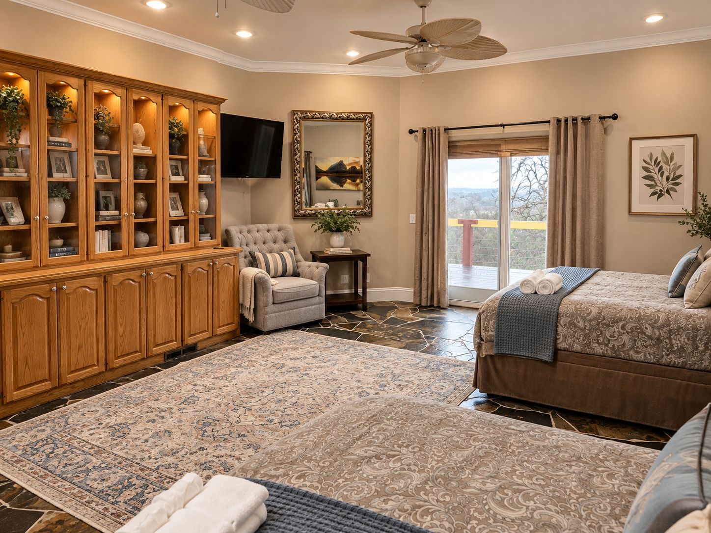 Bedroom with 2 queen-size beds, wall-mounted TV, and direct access to the main d