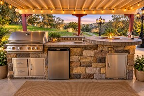 Gas BBQ right in front of the main entrance area with high top chairs for easy h