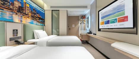A hotel room with a large bed, a desk, a TV screen, and a painting of a cityscape.