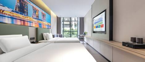 A modern hotel room with a large bed, a desk, and a view of a cityscape through the window.