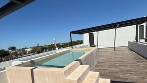 A rooftop pool with a clear view of the city skyline. - Apartment with Private Rooftop. Start your adventure here at Zefira - 2BR. (Mérida)