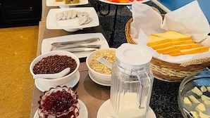 A buffet with various food items and a milk dispenser. - Rithy Rin Angkor Hotel (Siem Reap)