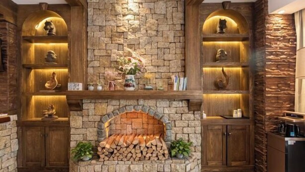 A stone fireplace with a log storage area, wooden shelves with decorative items, and a coffee machine on the right. - World Smart Hotel (Shanghai University of Finance and Economics Dabaishu Subway Station) (Shanghai)