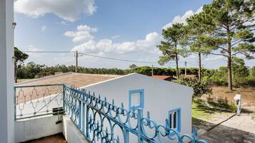 Enjoy the serene views of the surrounding neighborhood from this balcony.