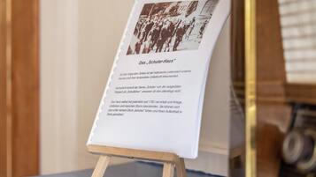 Historiallinen dokumentti, joka on esillä taulutelineessä, ja sen yhteydessä on valokuva ja teksti.